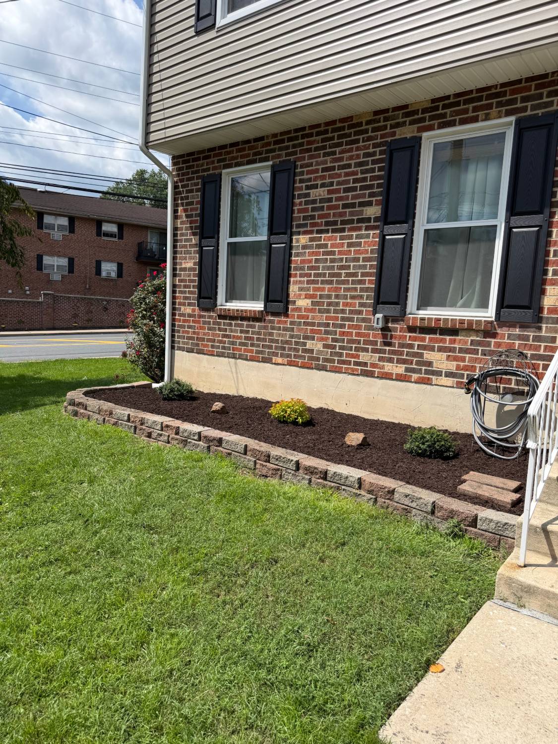 Finished foundation planting bed with paver block border in Ridley, PA